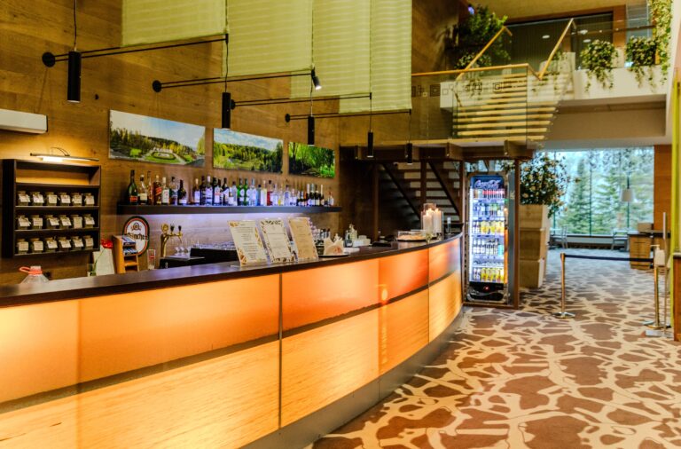 Toila Spa bar: a curved backlit counter, shelves and stairs to the upper level